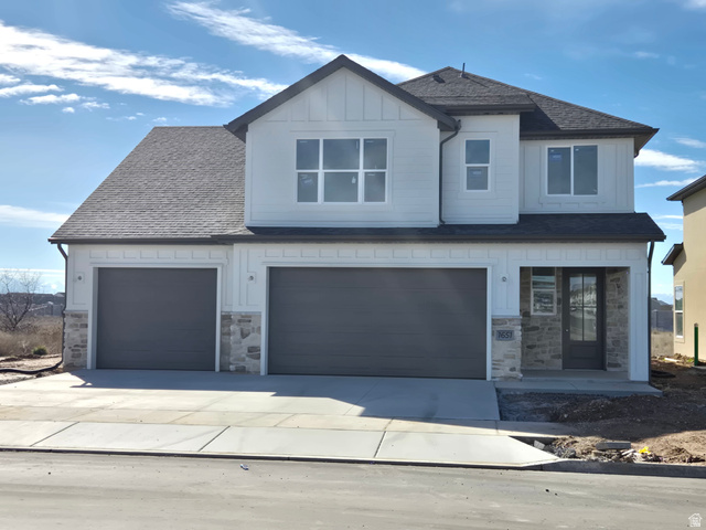 1651 West Ross Road Syracuse, UT 84075 - Photo 1 of 15 View of front of house featuring board and batten siding, stone siding, concrete driveway, a shingled roof, and an attached garage