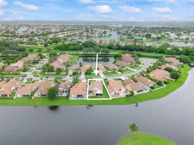 a aerial view of a house with a big yard plants and large trees