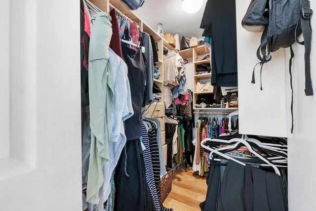 a bathroom with a granite countertop sink mirror vanity and toilet