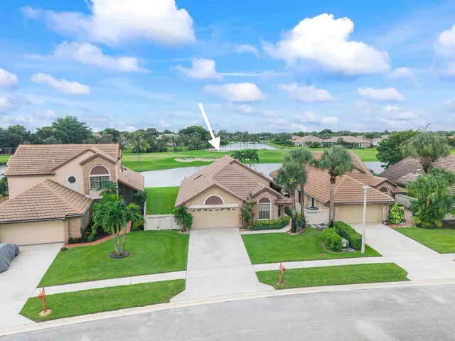 an aerial view of a house with garden space and a street view