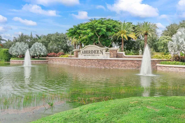 a front view of a building with a garden and plants