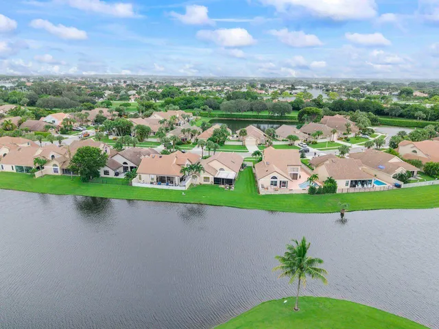 an aerial view of a house with outdoor space and a garden