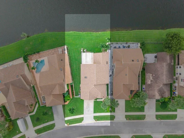 a view of a backyard with a fountain plants and palm trees