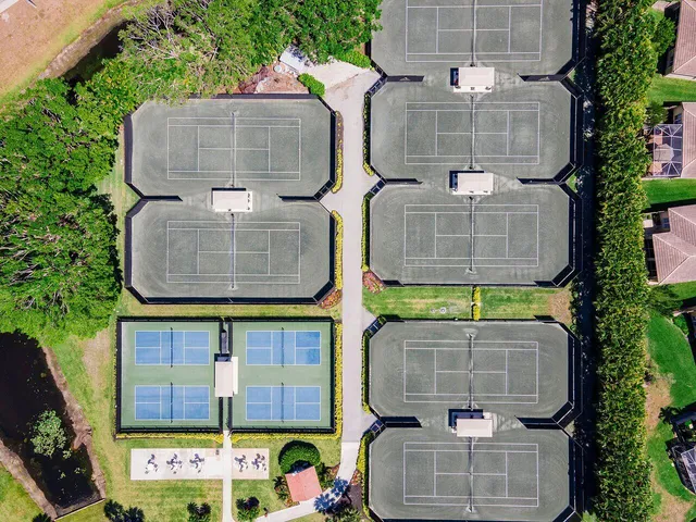 a front view of a house with a yard and a garden