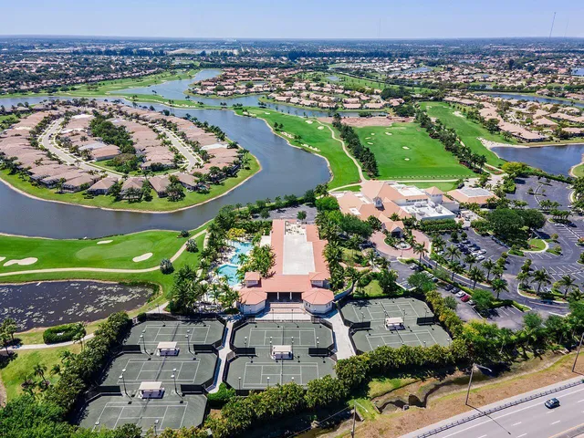 a aerial view of a house with a big yard and large trees
