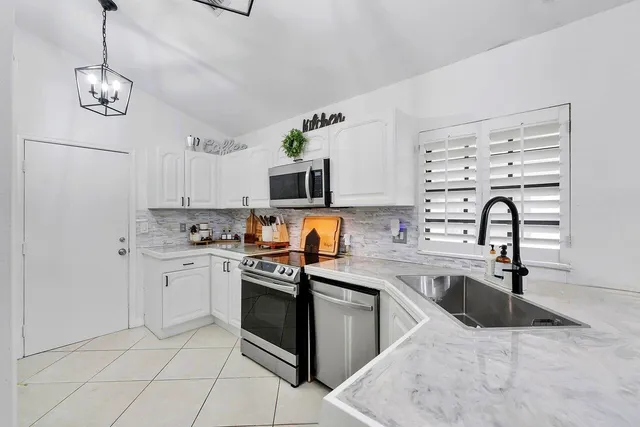 a living room with furniture a piano and a potted plant
