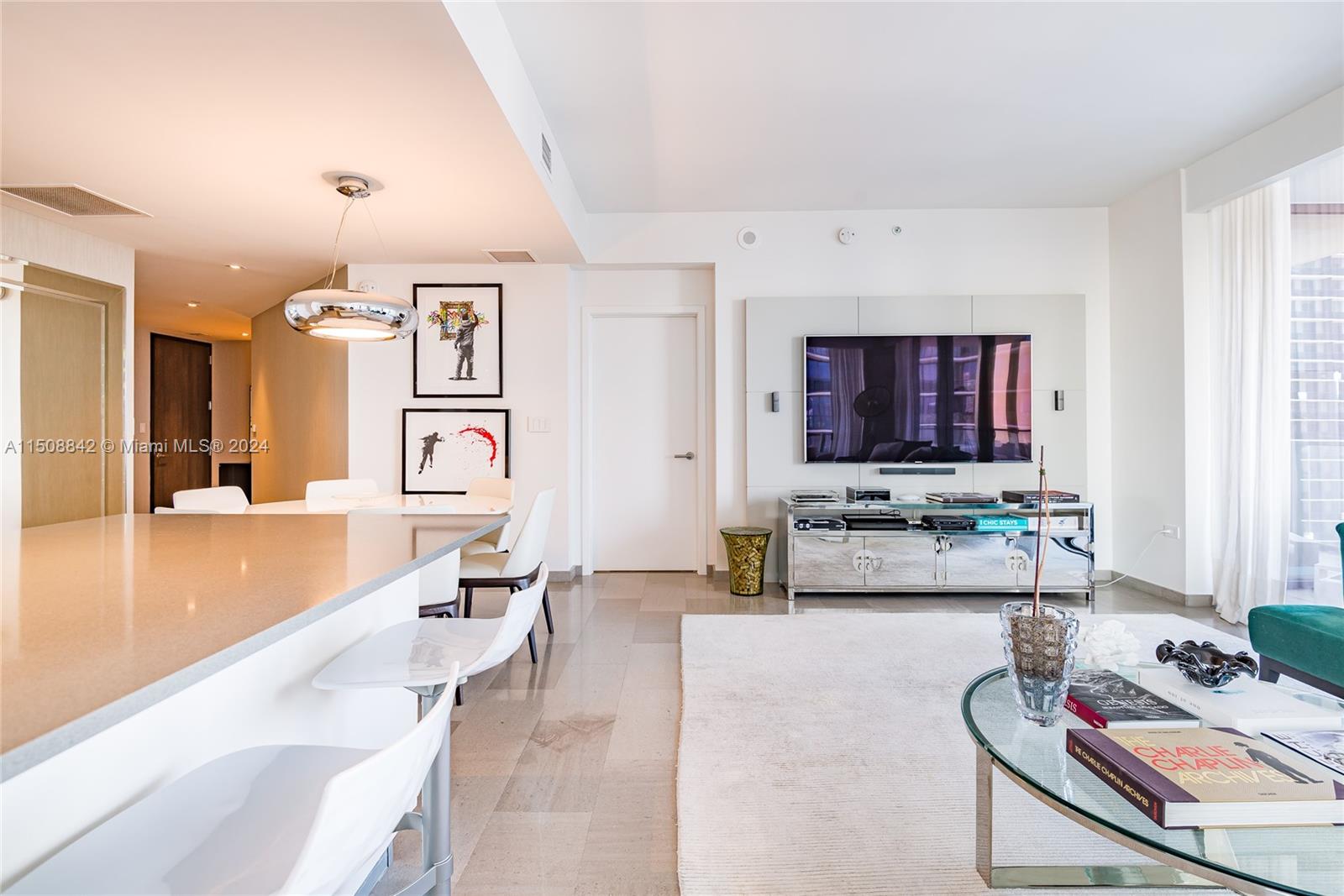 88 Southwest 7th Street, Unit 3301 Miami, FL 33130 - Photo 11 of 54 a living room with furniture and a flat screen tv