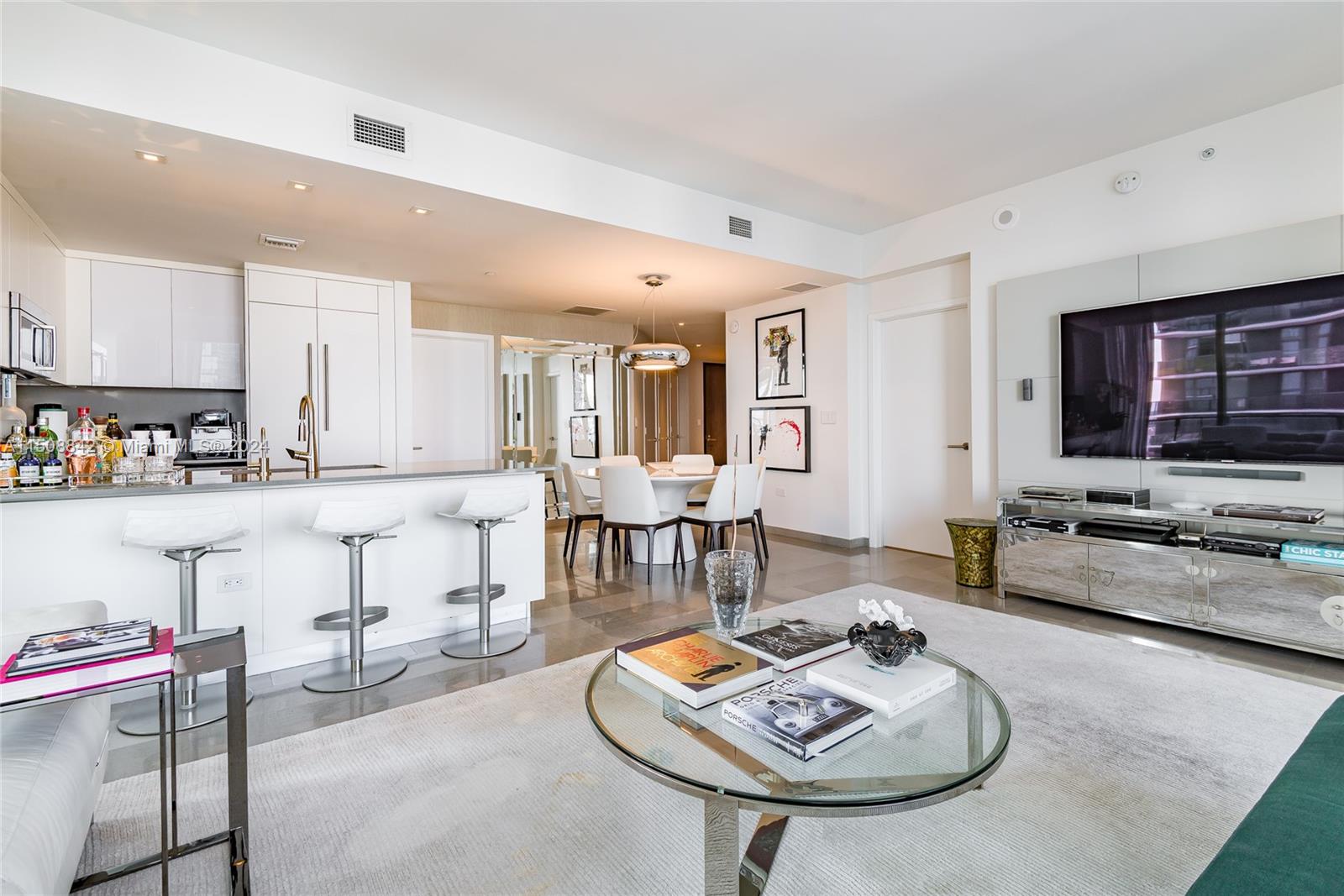 88 Southwest 7th Street, Unit 3301 Miami, FL 33130 - Photo 12 of 54 a living room with furniture and a flat screen tv