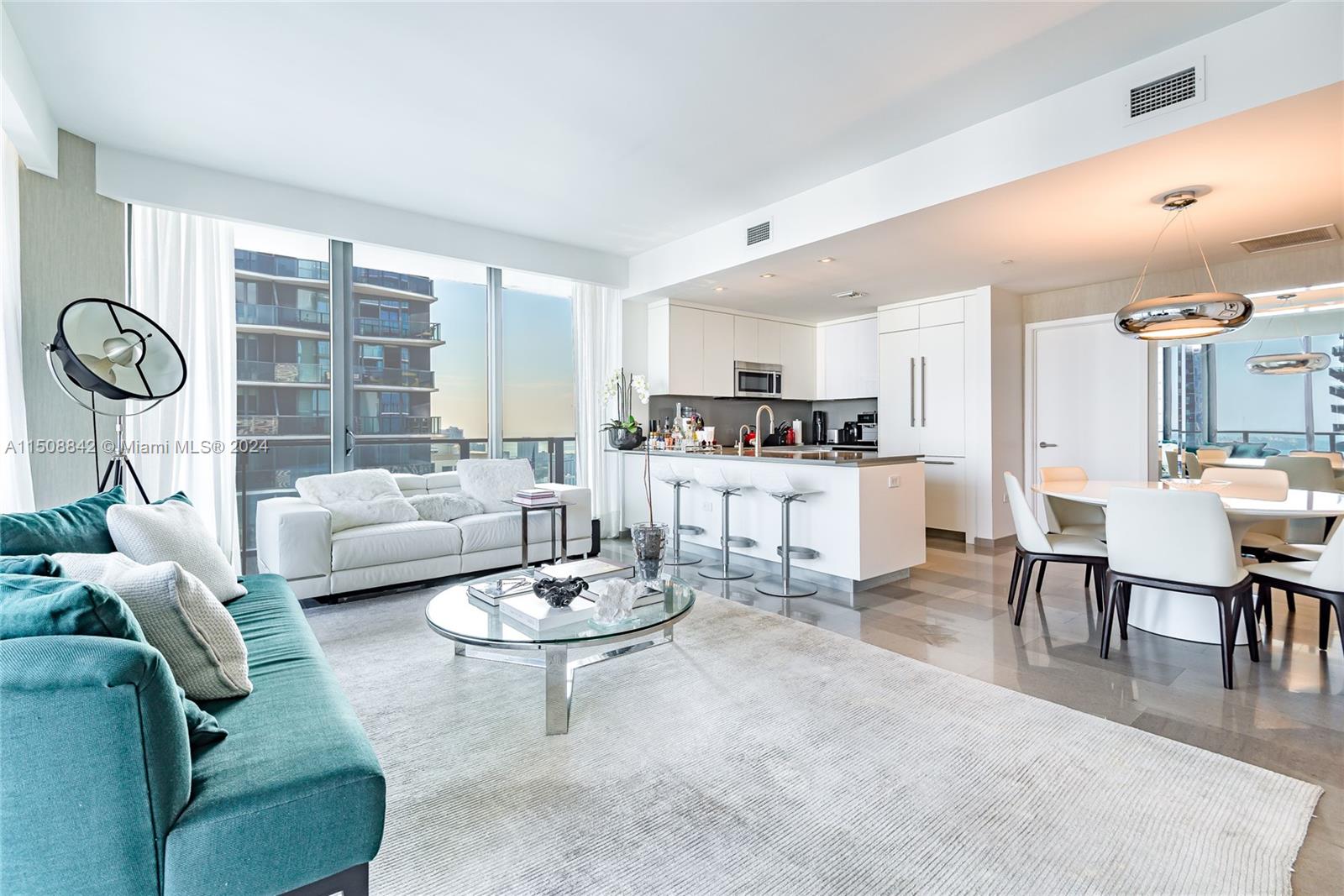 88 Southwest 7th Street, Unit 3301 Miami, FL 33130 - Photo 14 of 54 a living room with furniture a rug and kitchen view