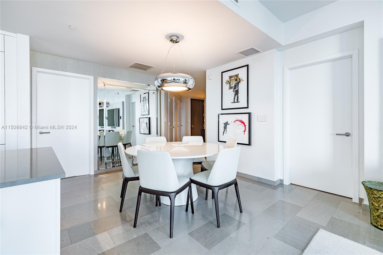 88 Southwest 7th Street, Unit 3301 Miami, FL 33130 - Photo 15 of 54 a view of a dining room with furniture and wooden floor
