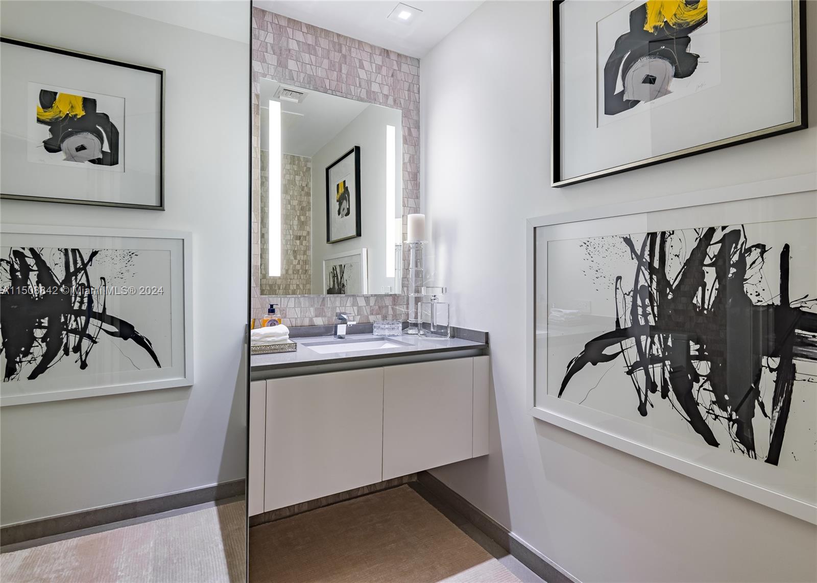 88 Southwest 7th Street, Unit 3301 Miami, FL 33130 - Photo 17 of 54 a bathroom with a sink and a mirror