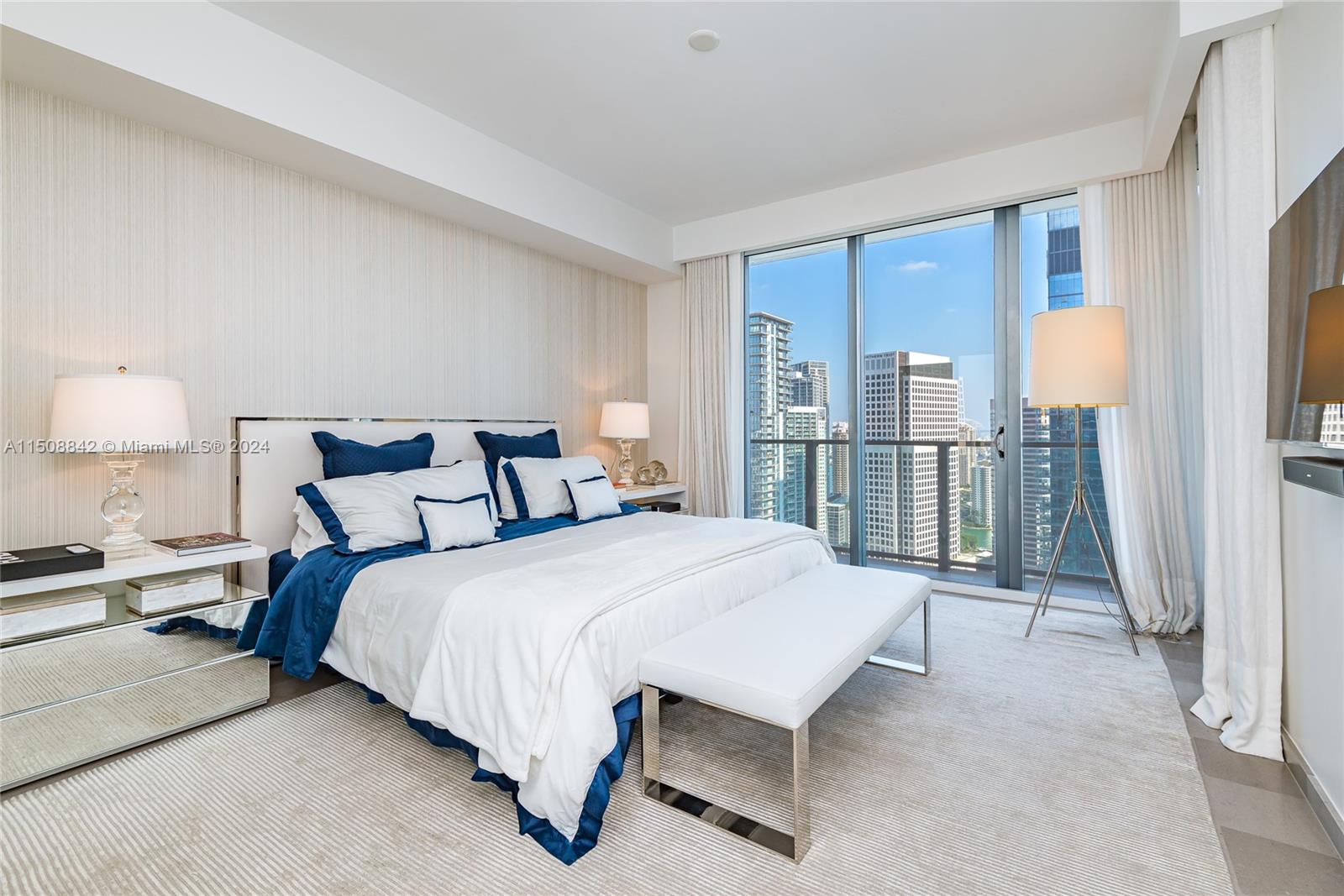 88 Southwest 7th Street, Unit 3301 Miami, FL 33130 - Photo 21 of 54 a bed room with a bed and a lamp