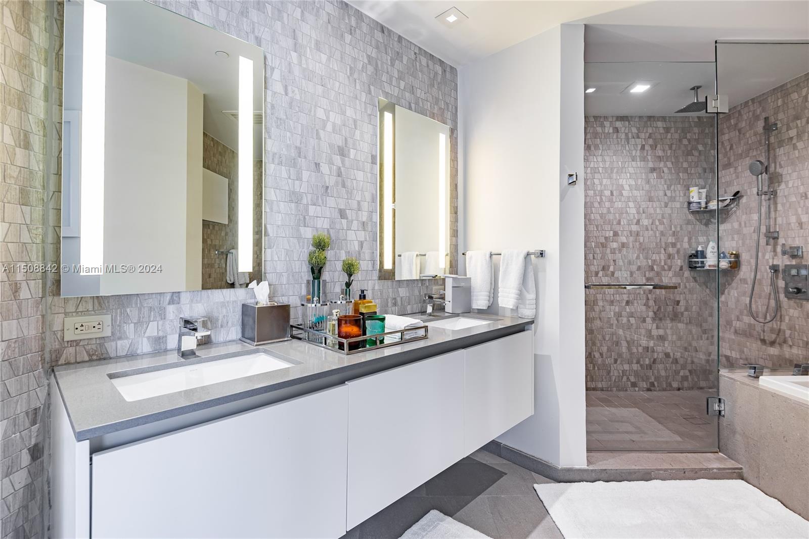 88 Southwest 7th Street, Unit 3301 Miami, FL 33130 - Photo 25 of 54 a bathroom with a shower sink and mirror