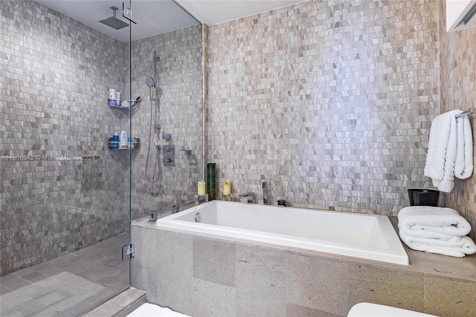 88 Southwest 7th Street, Unit 3301 Miami, FL 33130 - Photo 26 of 54 a bathroom with a bathtub and shower