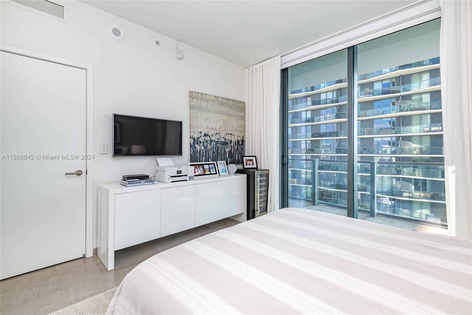 88 Southwest 7th Street, Unit 3301 Miami, FL 33130 - Photo 29 of 54 a bedroom with a bed and a flat screen tv