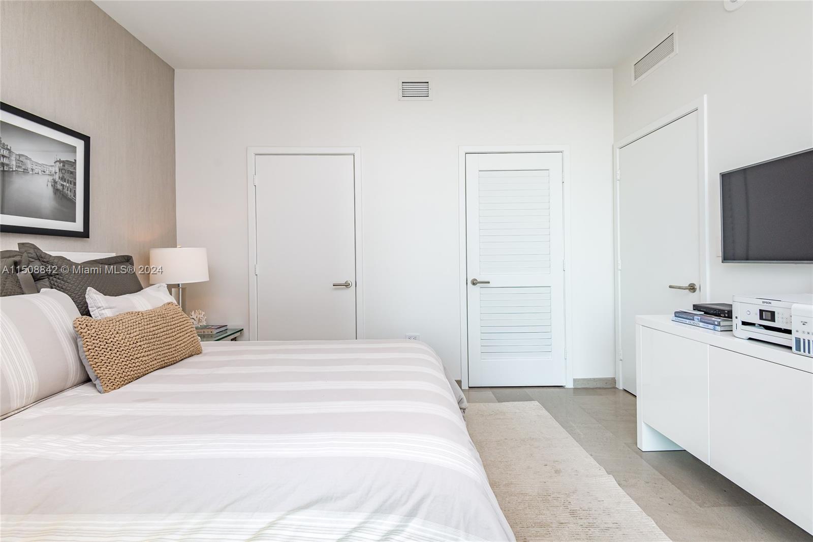 88 Southwest 7th Street, Unit 3301 Miami, FL 33130 - Photo 30 of 54 a bedroom with a bed and a flat screen tv