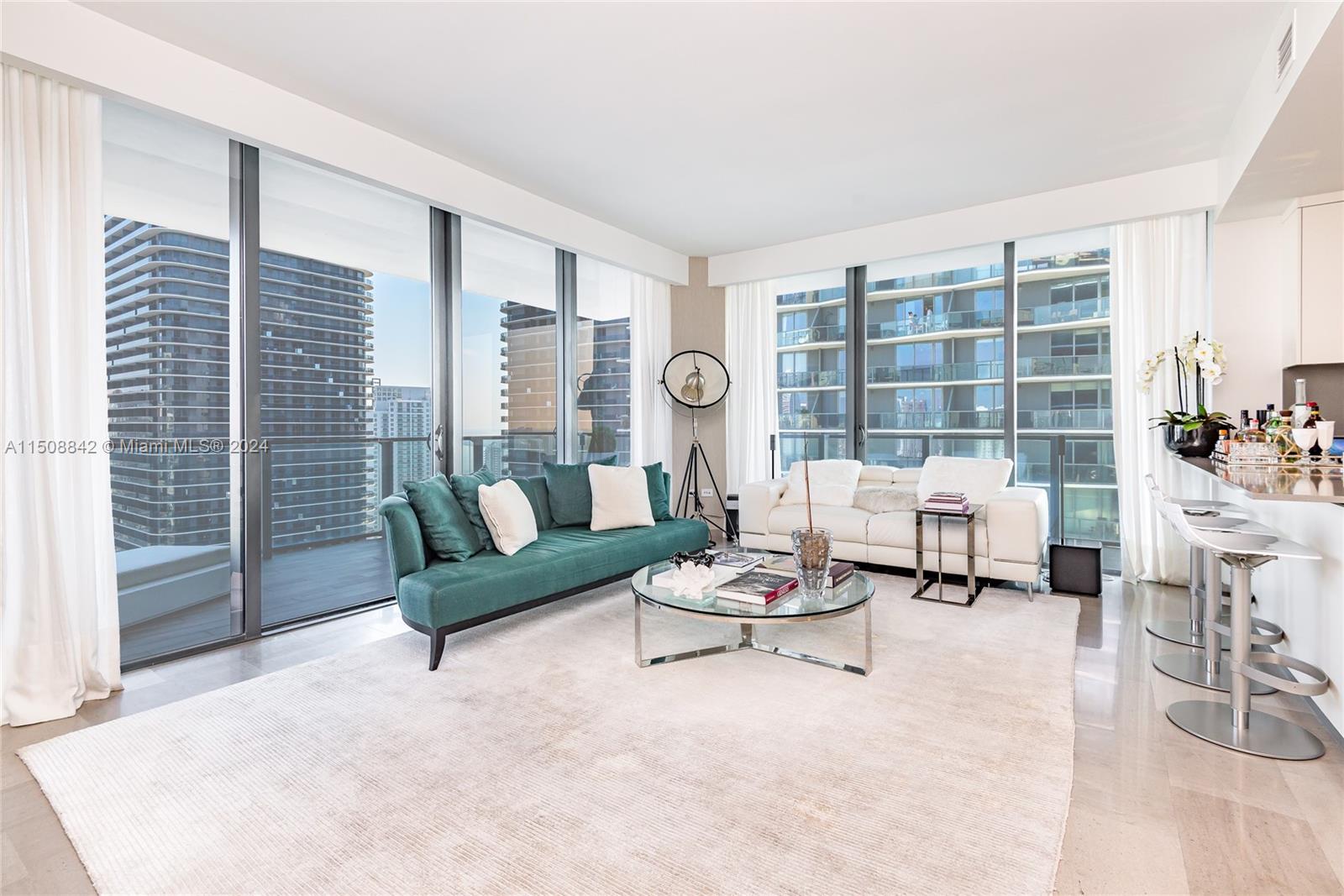 88 Southwest 7th Street, Unit 3301 Miami, FL 33130 - Photo 3 of 54 a living room with furniture and a large window