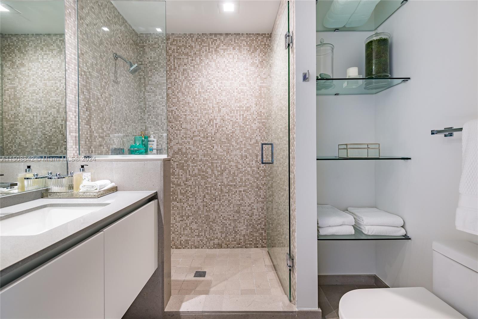 88 Southwest 7th Street, Unit 3301 Miami, FL 33130 - Photo 31 of 54 a bathroom with a sink a toilet and shower