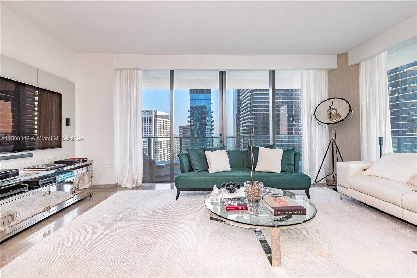 88 Southwest 7th Street, Unit 3301 Miami, FL 33130 - Photo 4 of 54 a living room with furniture and a flat screen tv