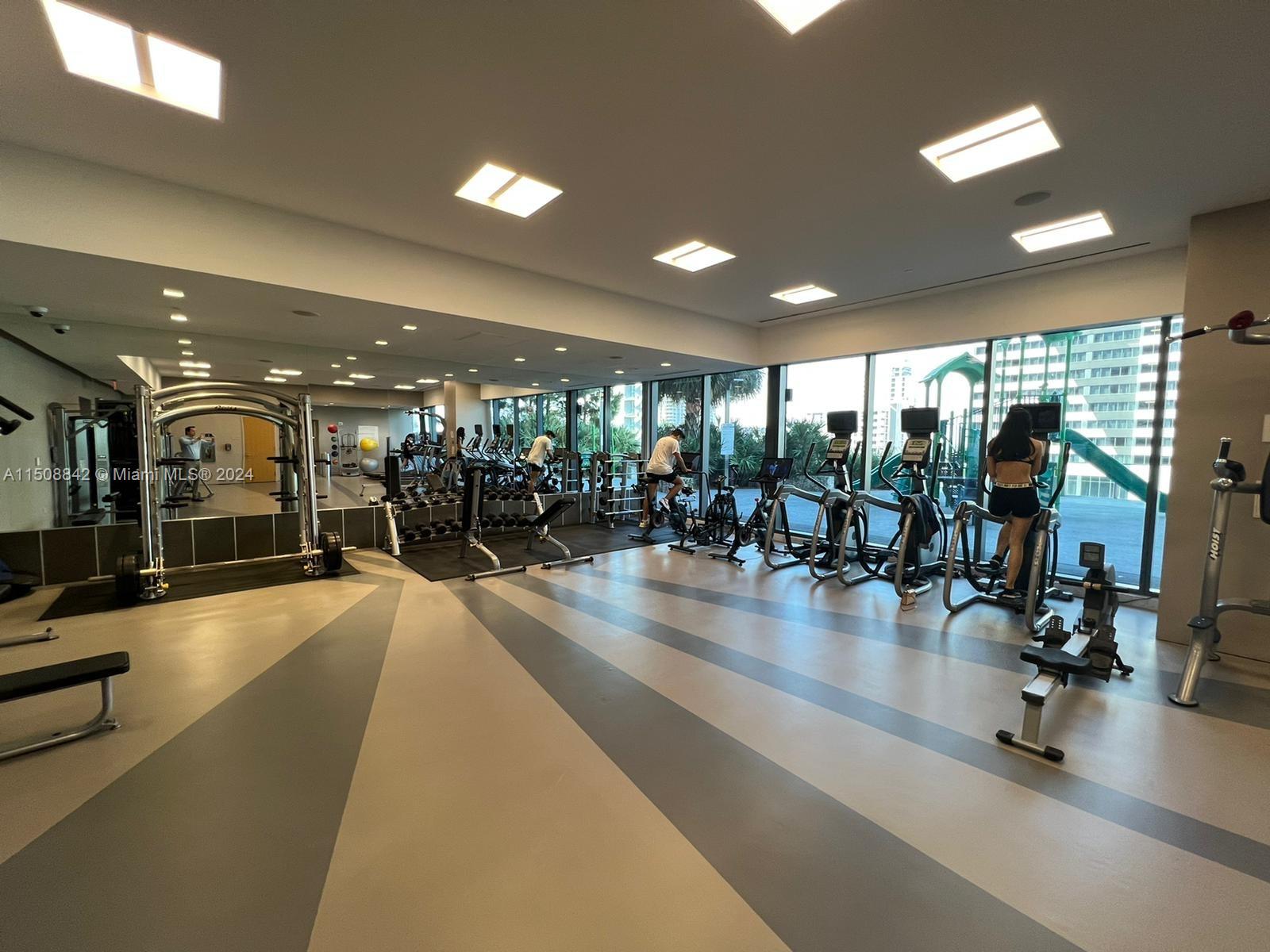 88 Southwest 7th Street, Unit 3301 Miami, FL 33130 - Photo 46 of 54 a view of a room with gym equipment and a large window
