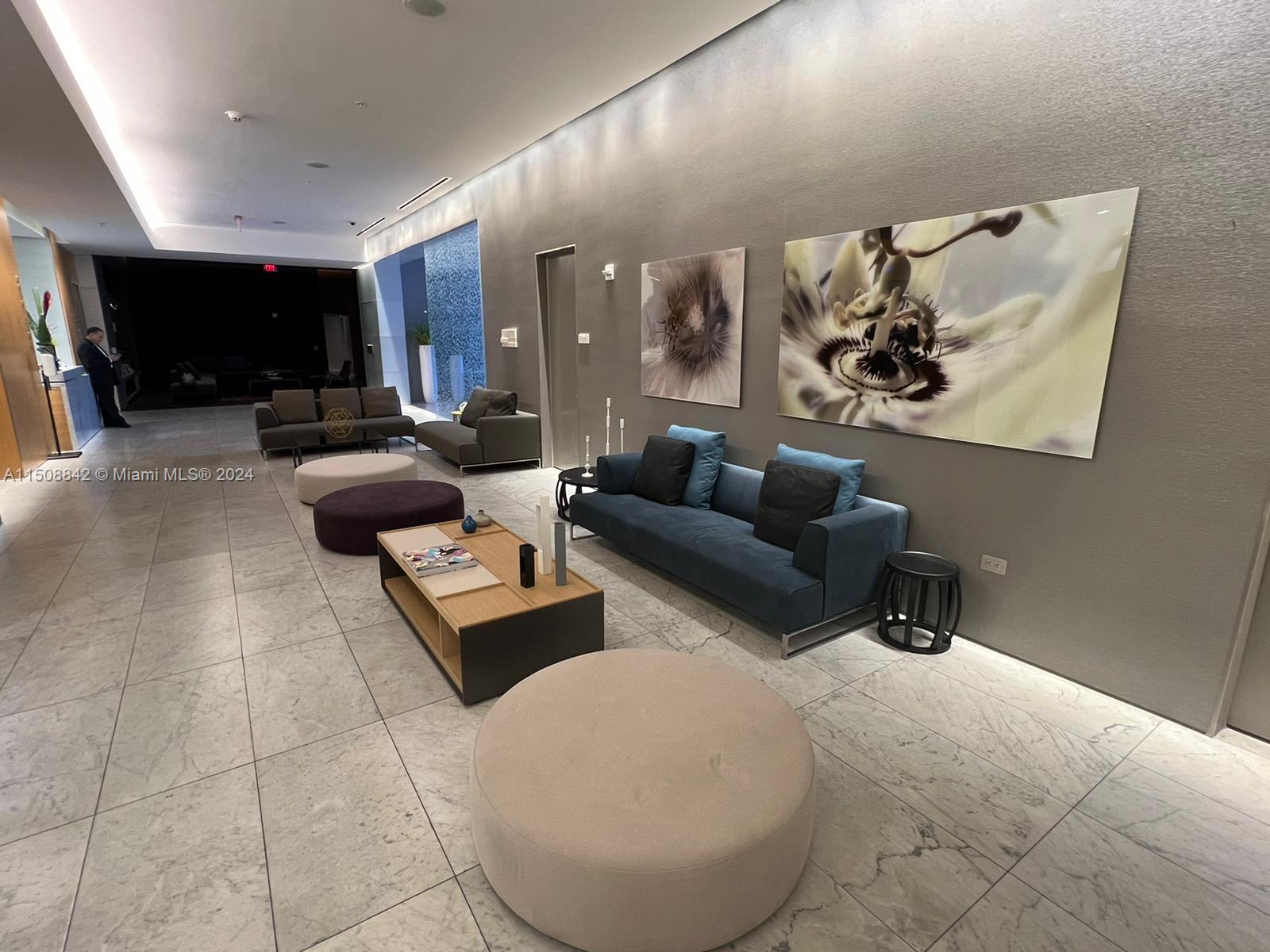 88 Southwest 7th Street, Unit 3301 Miami, FL 33130 - Photo 47 of 54 a living room with furniture and a flat screen tv