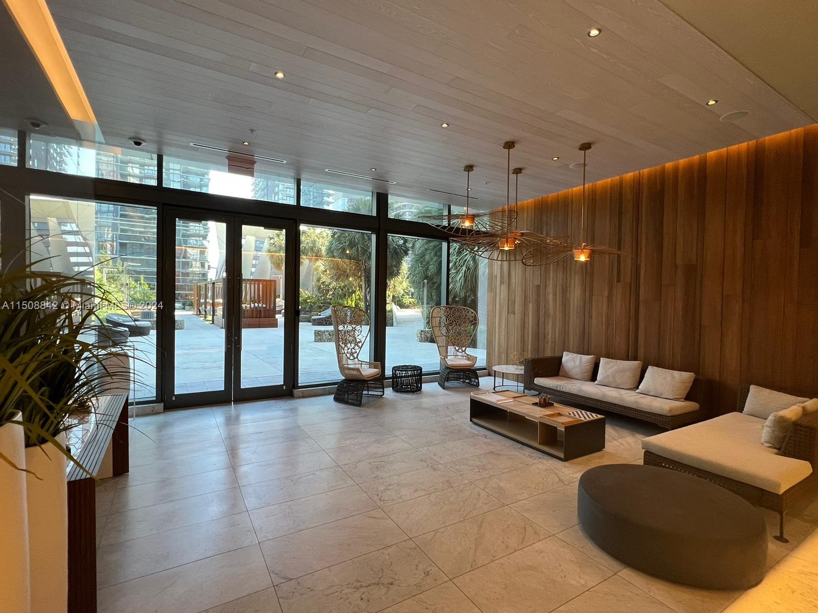 88 Southwest 7th Street, Unit 3301 Miami, FL 33130 - Photo 50 of 54 a lobby with furniture and floor to ceiling window