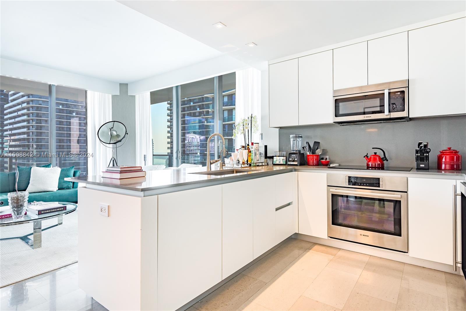 88 Southwest 7th Street, Unit 3301 Miami, FL 33130 - Photo 5 of 54 a kitchen with stainless steel appliances granite countertop a stove and cabinets