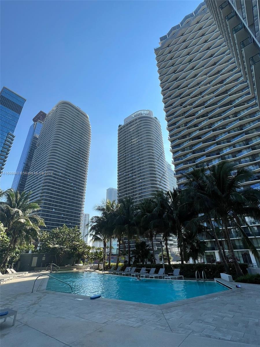 88 Southwest 7th Street, Unit 3301 Miami, FL 33130 - Photo 52 of 54 a front view of a residential apartment building with a yard