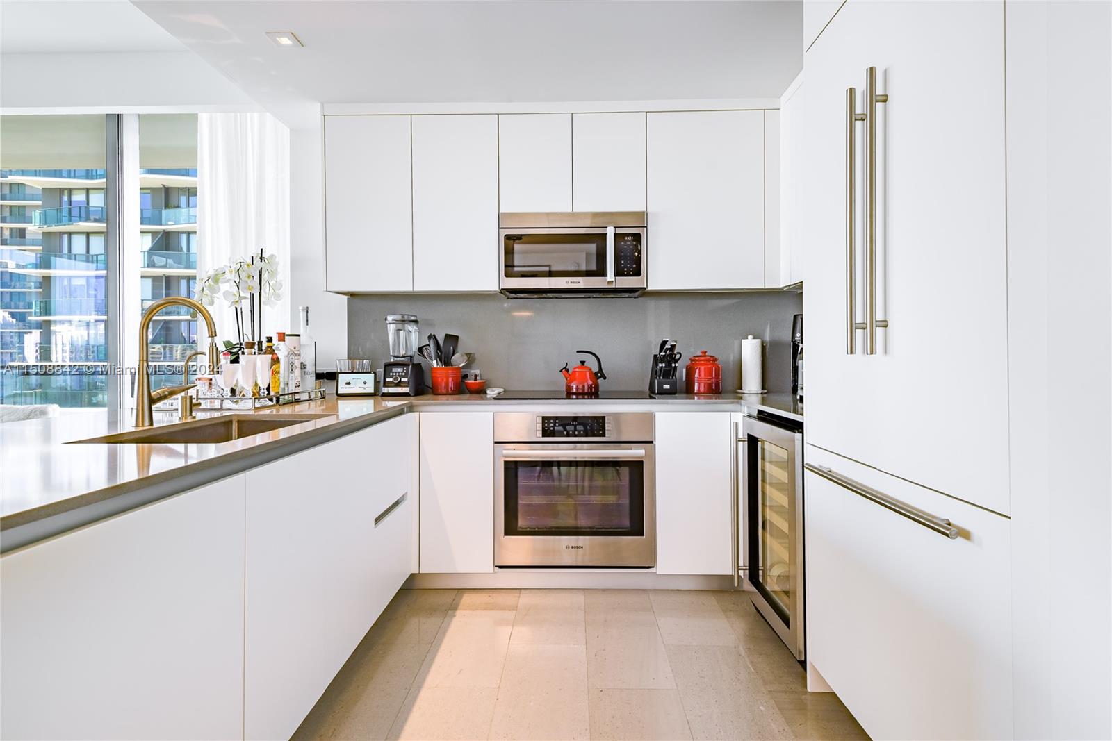 88 Southwest 7th Street, Unit 3301 Miami, FL 33130 - Photo 6 of 54 a kitchen with stainless steel appliances granite countertop a refrigerator and a stove top oven