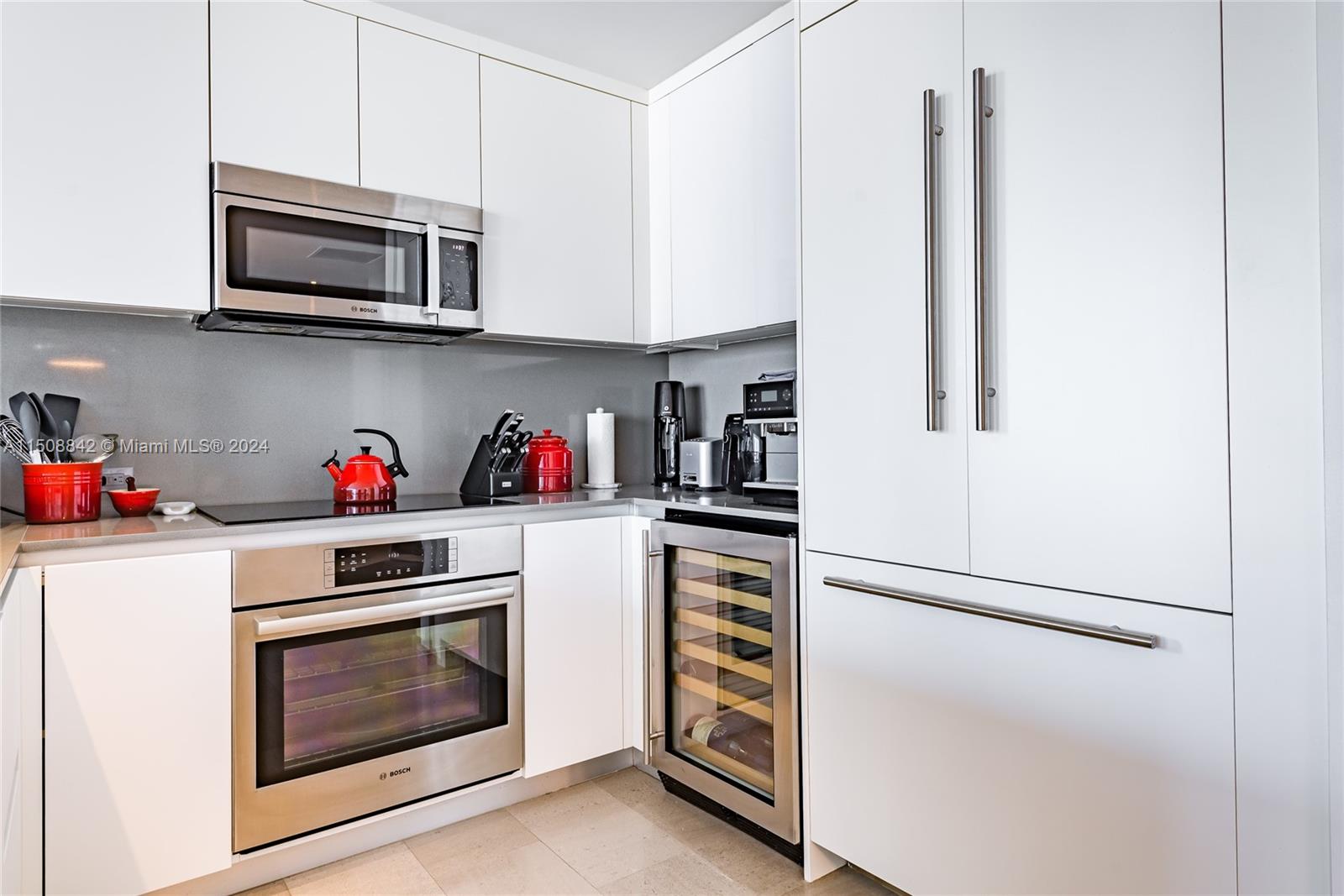88 Southwest 7th Street, Unit 3301 Miami, FL 33130 - Photo 7 of 54 a kitchen with stainless steel appliances white cabinets and a refrigerator