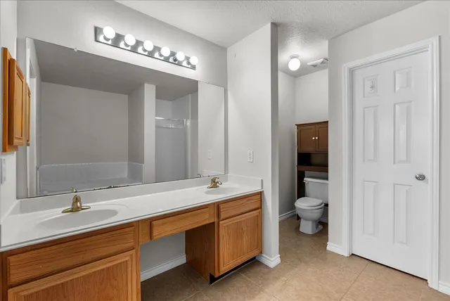 a bedroom with a bed lamp and a window