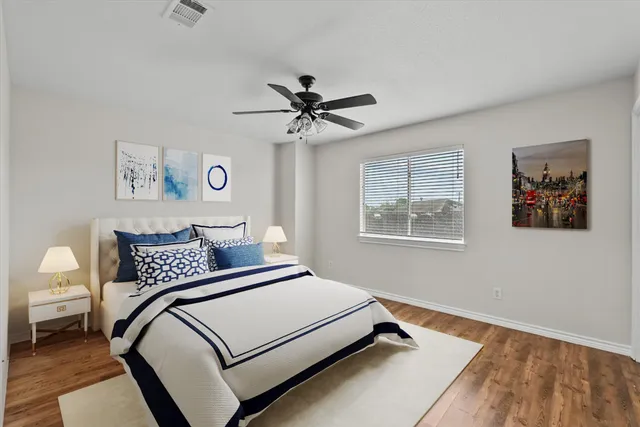 a bedroom with a large bed and a chandelier