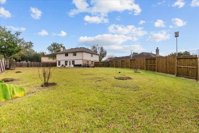 a view of a house with a yard and sitting area