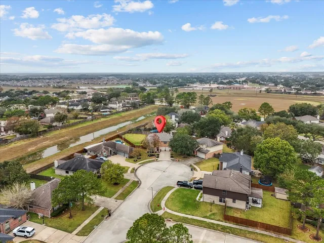 an aerial view of a house with a yard basket ball court and outdoor seating