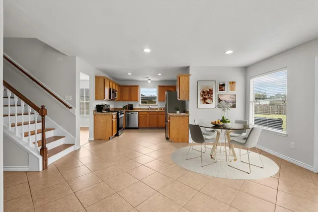 a view of a hallway with entryway and stairs