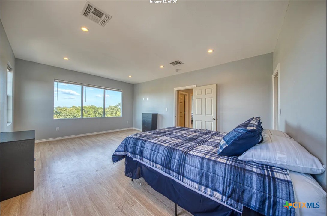 729 Clay Ridge Canyon Lake, TX 78133 - Photo 6 of 13 a bedroom with a bed and a window