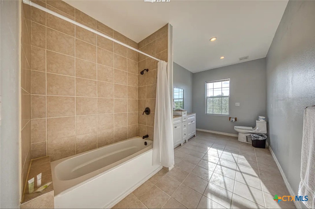 729 Clay Ridge Canyon Lake, TX 78133 - Photo 7 of 13 a bathroom with a bathtub and a toilet