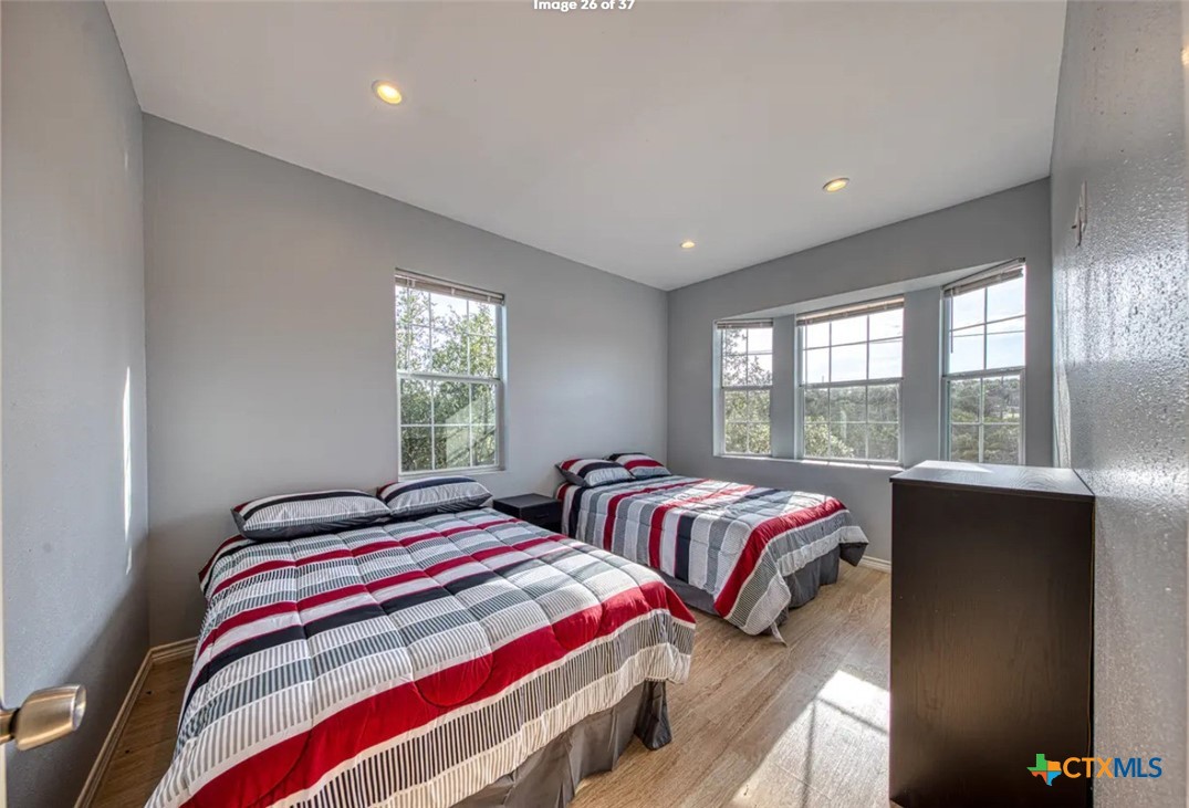 729 Clay Ridge Canyon Lake, TX 78133 - Photo 8 of 13 a bedroom with two beds and a large window