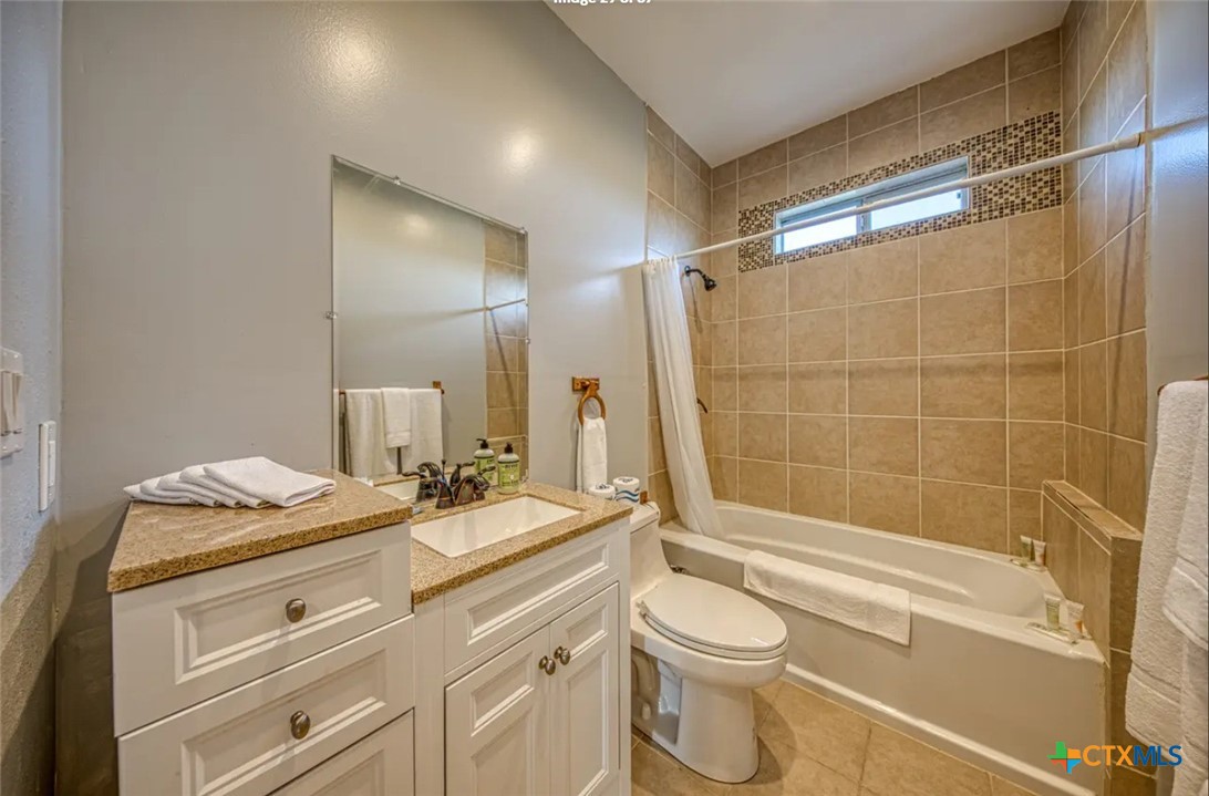 729 Clay Ridge Canyon Lake, TX 78133 - Photo 9 of 13 a bathroom with a granite countertop sink toilet a mirror and shower