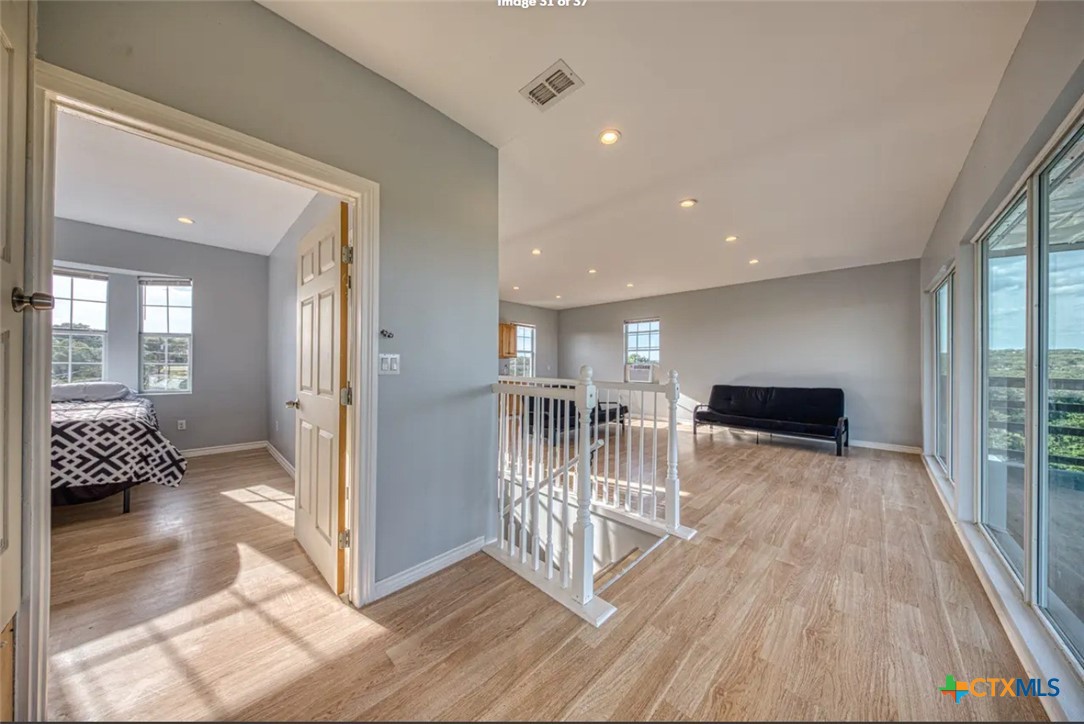 729 Clay Ridge Canyon Lake, TX 78133 - Photo 10 of 13 a view of a hallway with wooden floor and windows