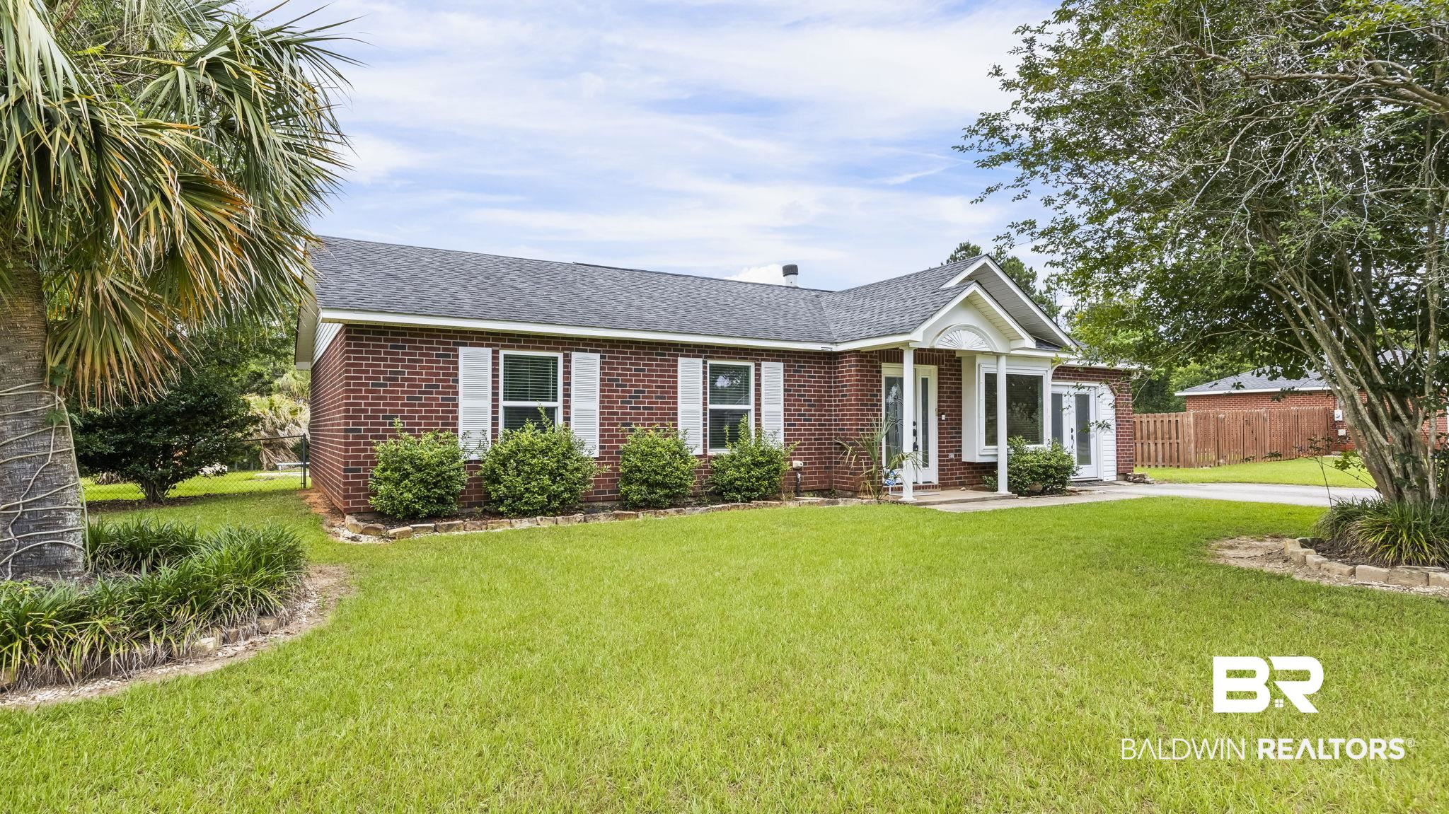 15096 Highland Circle Foley, AL 36535 - Photo 1 of 52 Brick exterior with white shutters and a gabled entry