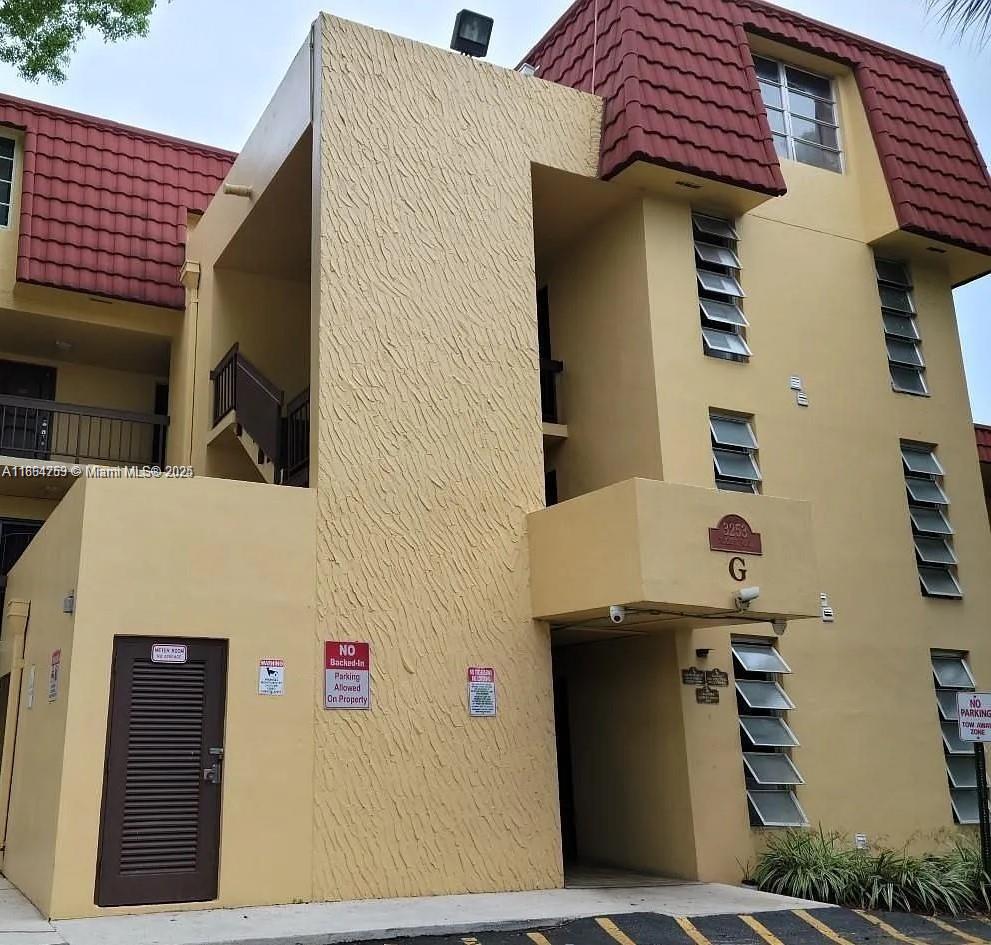 3253 Foxcroft Road, Unit G107 Miramar, FL 33025 - Photo 3 of 11 a front view of a building