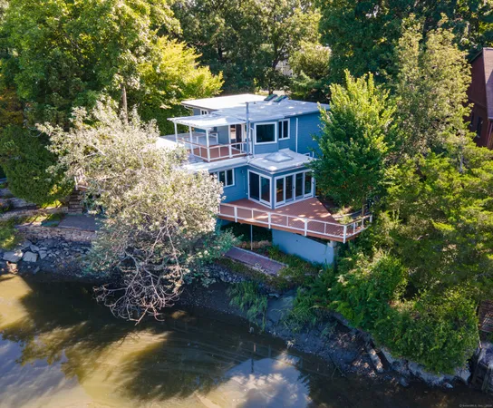 a aerial view of a house with a yard swimming pool and lake view