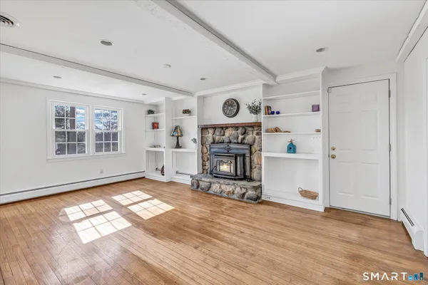 a view of a livingroom with wooden floor and a window