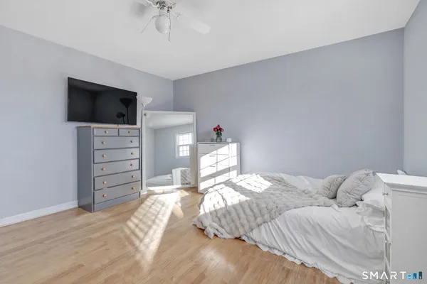 a bedroom with bed couch and a window