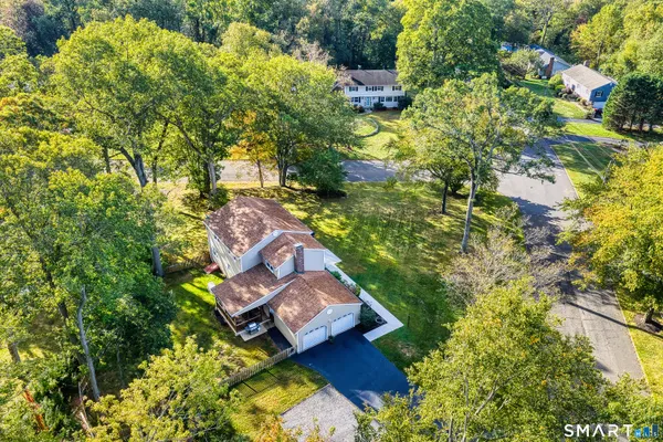 an aerial view of a house with a yard basket ball court and outdoor seating