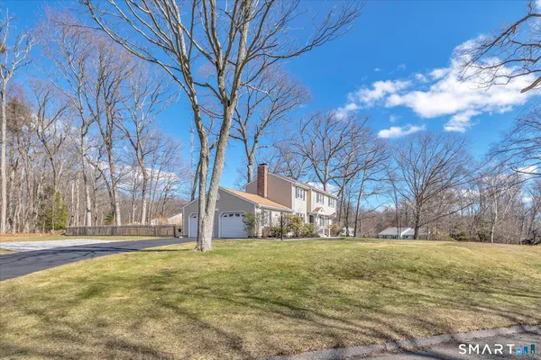 an aerial view of a house with a yard basket ball court and outdoor seating