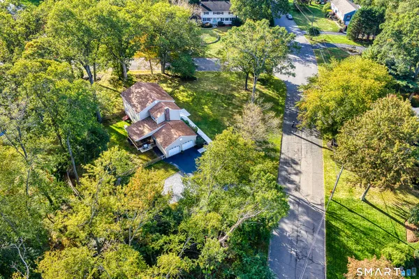 an aerial view of a house with a yard basket ball court and outdoor seating