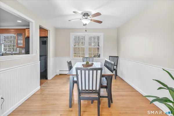a view of a dining room with furniture window and wooden floor