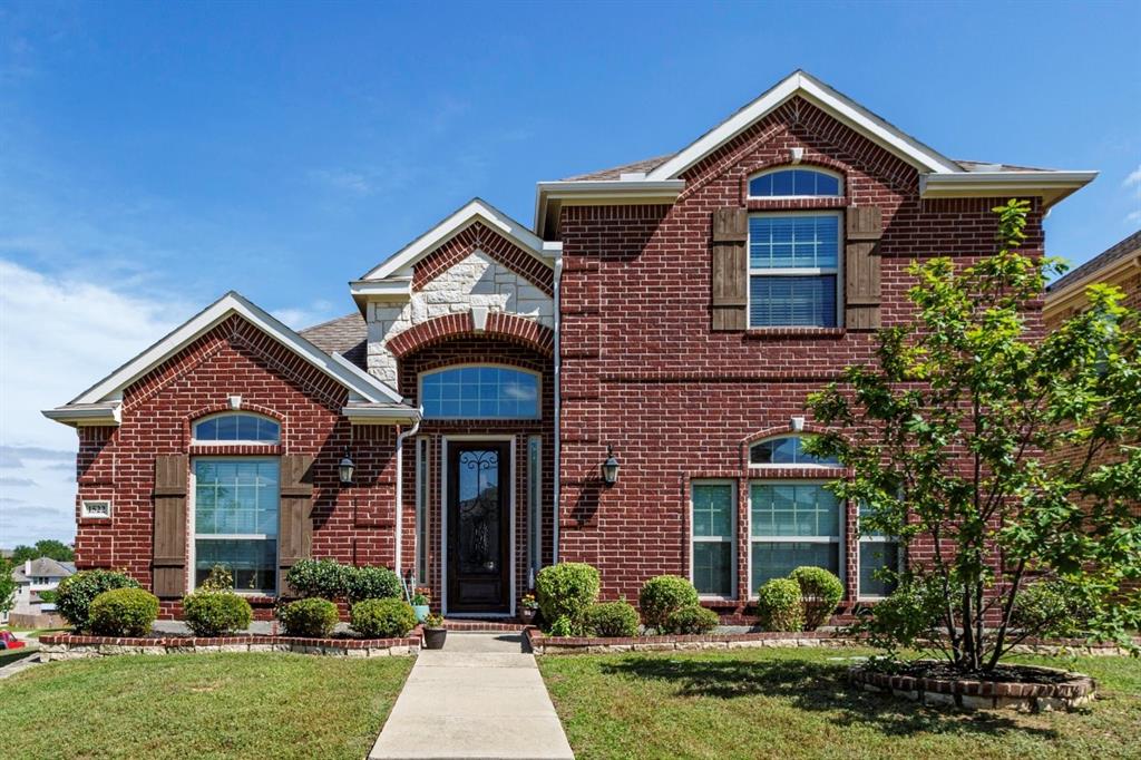 Brick and stone façade with arched entryway